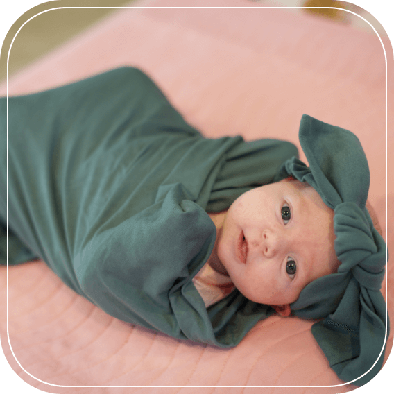 kid sleeping with green blanket