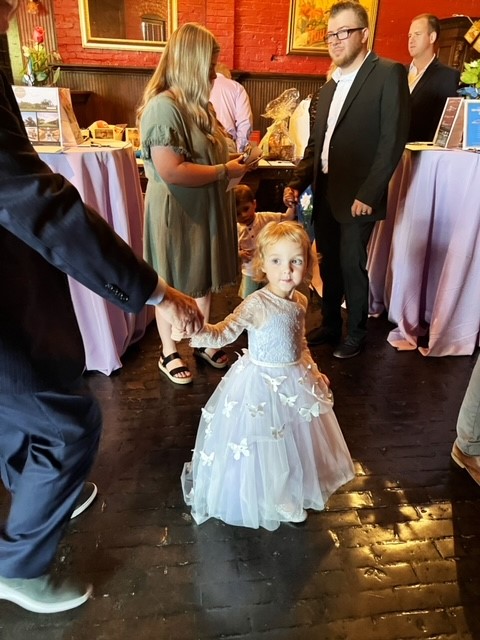A toddler wearing a beautiful gown